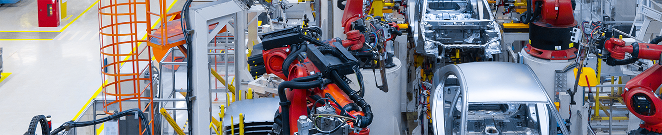car production conveyer belt with machines on the side putting it together
